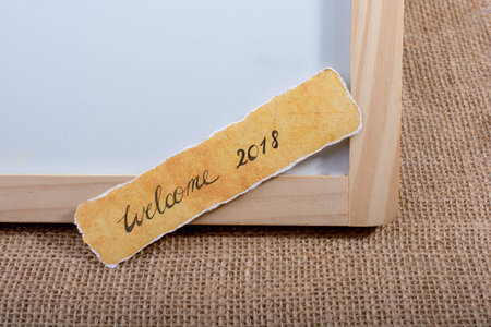 Welcome 2018 wording written on a torn paper