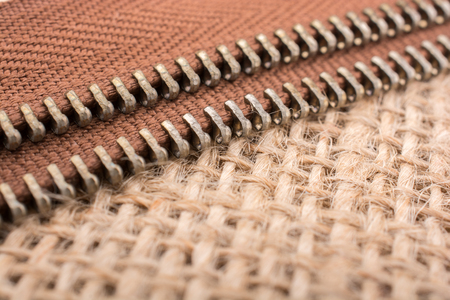 Parts of the brown color zipper on linen canvas backgroundの写真素材