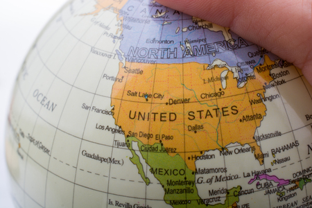 Hand holding a globe  with map on itの写真素材