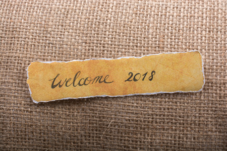 Welcome 2018 new year greeting phrase  lettering on torn paperの写真素材