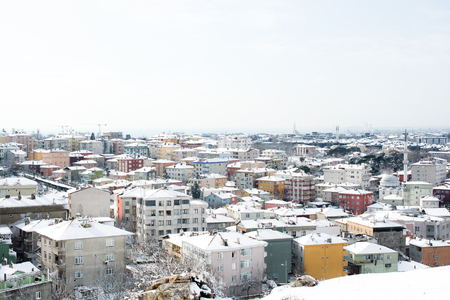 A winter view from the city of Istanbul with houses covered with white snowの写真素材