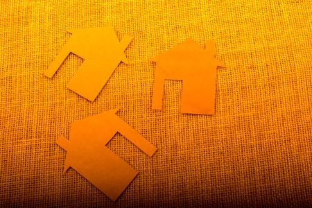 Little house shape cut out of paper on a canvas backgroundの写真素材