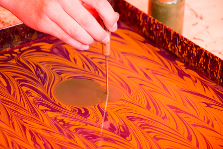 Hand drawing with stick stained inks on water surfaceの写真素材