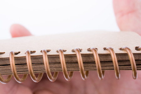 Hand holding a spiral notebookの写真素材