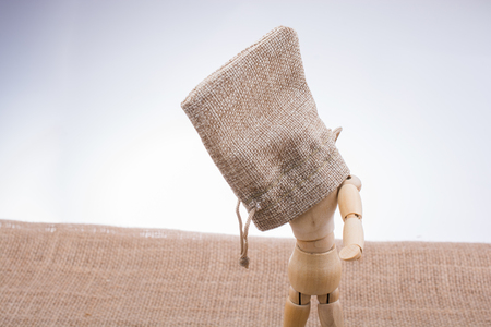 man made of wood with a sack in handの写真素材