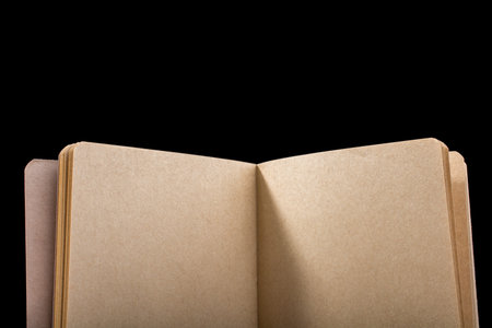 Brown color notebook open on a black background