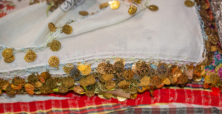 Plenty of fake gold coins are on the scarf edgesの写真素材