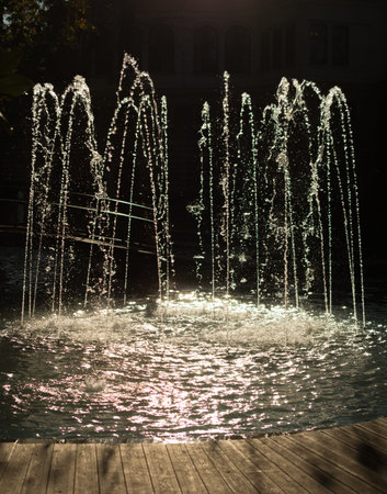 The fountains gushing sparkling water in a pool in a parkの写真素材