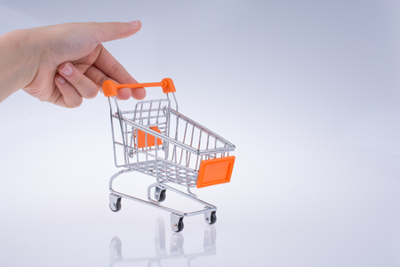Hand holding a Cart on a white backgroundの写真素材