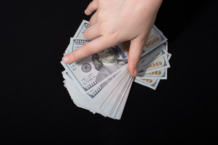 Hand holding American dollar  banknotes isolated on white backgroundの写真素材