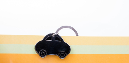 automobile business concept with a metal car icon on colorful backgroundの写真素材