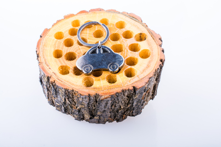 automobile business concept with a metal car icon on wooden logの写真素材
