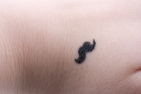moustache design on a hand in a white backgroundの写真素材