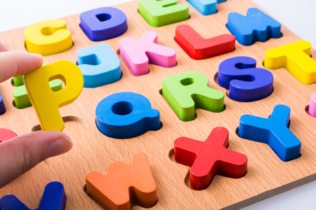 Letter P and Colorful letters on board on white backgroundの写真素材