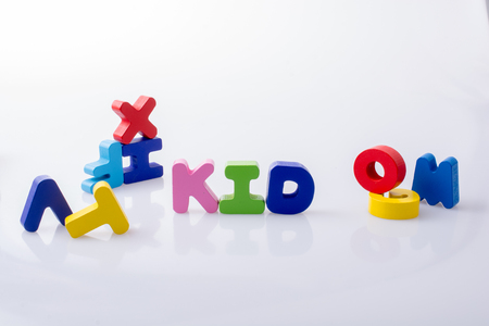 the word KID written with colorful letter blocks on whiteの写真素材