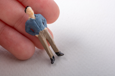 Tiny figurine of man miniature model in handの写真素材