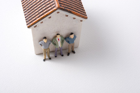 Tiny figurine of man miniature before a houseの写真素材