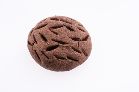 Chocolate cookie with a pattern on a white backgroundの写真素材