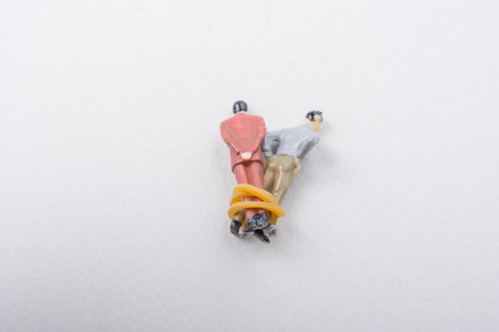 Tiny figurine of men model wrapped in ropeの写真素材