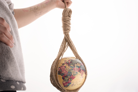 globe hanging in rope on white backgroundの写真素材