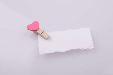 Pink hearted clip on a white note paperの写真素材