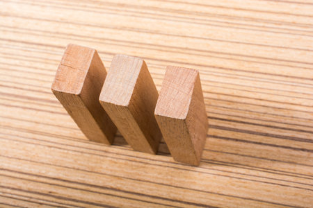 piece of domino elements made of wood on wooden texture