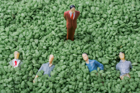 Group of tiny figurine of man in green sandの写真素材