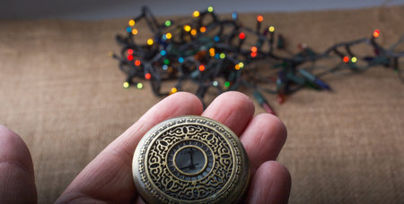 Retro style pocket watch in hand on black background