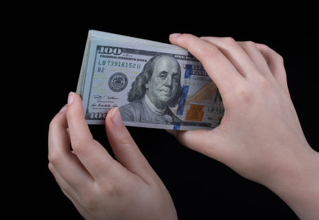 Hand holding American dollar  banknotes isolated on white background