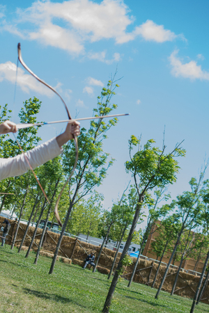 Archer with bow  in traditional clothes shooting an arrowのeditorial素材