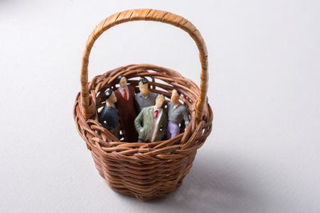 Tiny figurine of group of men miniature model in basketの写真素材
