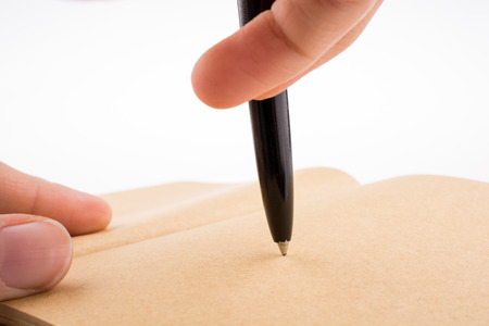 Hand writing on a notebook with a penの写真素材