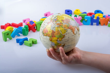 Little model gobe in hand with colourful letters behind