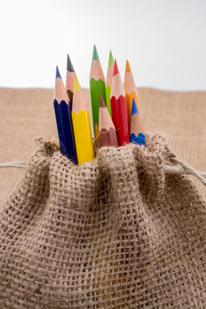 Color Pencils in a linen sack on canvasの写真素材