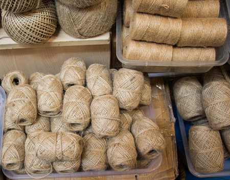 Plenty of spools or rolls of brown color linen string