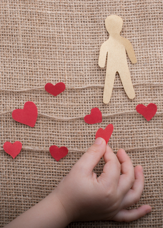 Man shape cut out of paper in hand in the viewの写真素材