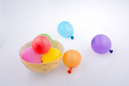 Colorful small baloons in a globe on a white backgroundの写真素材