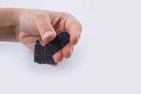 Hand holding a black arrow on a white backgroundの写真素材