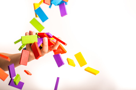 Falling colorful domino onto a  handの写真素材