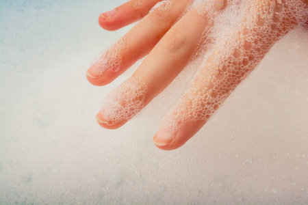 Hand washing and soap foam on a foamy background