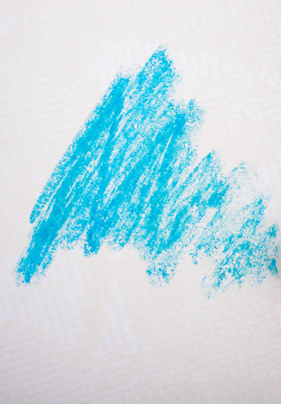 Blue color crayon placed on a notebookの写真素材
