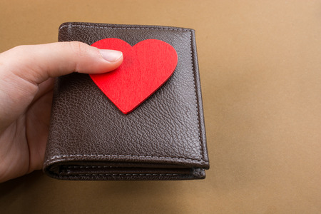 Brown leather wallet in hand  saving and finance conceptの写真素材