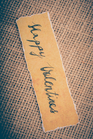 Valentine's day wording on torn paper as Love conceptの写真素材