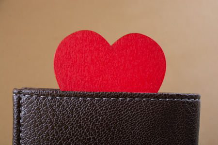 Red heart and wallet in hand  saving and finance conceptの写真素材