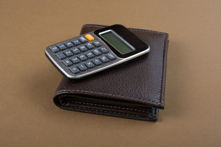 Calculator and wallet as  saving and finance conceptの写真素材