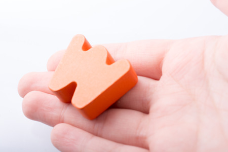Hand holding letter cube W of made of woodの写真素材