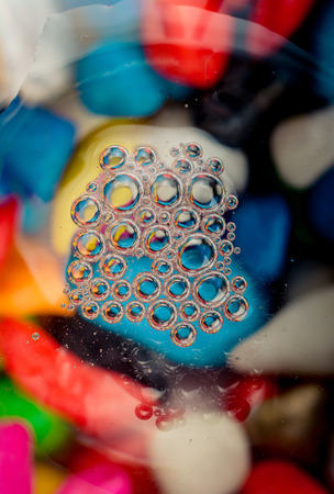 Colorful water bubbles on a glass ground in viewの写真素材