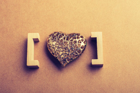 Gold color heart shaped  decorative object in brackets in viewの写真素材