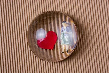 Woman figurine and Love concept with red paper hearts