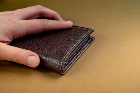Brown leather wallet in hand  saving and finance concept